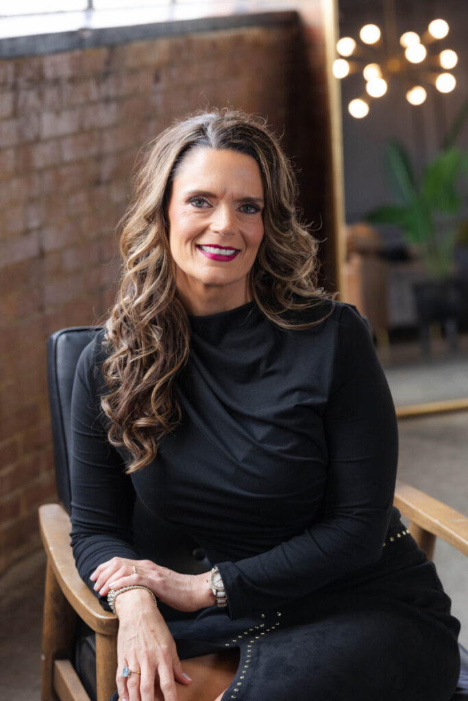 Brooke Unruh, public speaker and legal advisor, seated and smiling during a professional portrait session